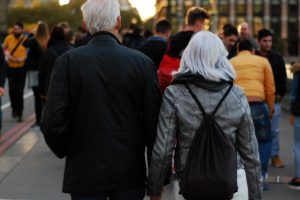 husband and wife walking through city