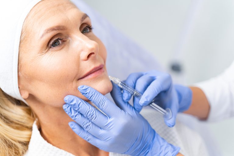 Serene blonde patient undergoing an anti-aging treatment