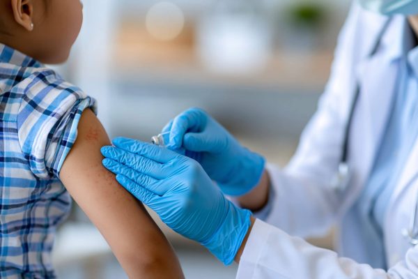 Close-up of a female dermatologists hands examining a childs skin rash in a medical clinic pediatric dermatology concept child skin examination photography clinic