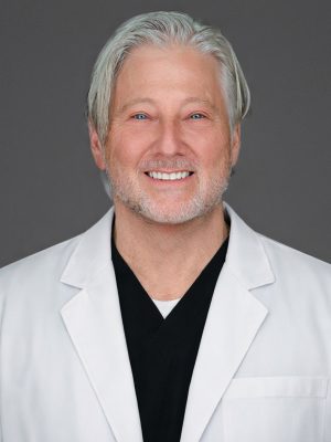 Dr. David Cohen in white coat