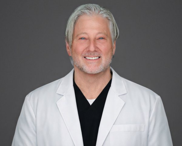 Dr. David Cohen in white coat